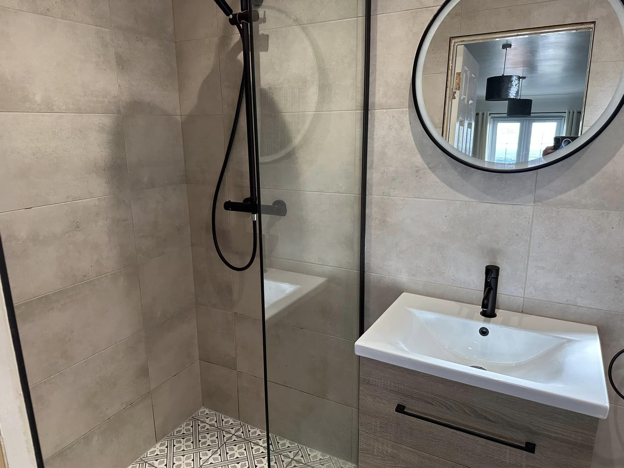 Modern beige bathroom with black fixtures